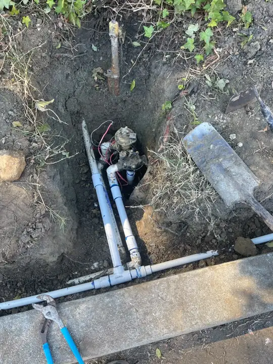 Irrigation valve installation in a planter next to a parking lot in Mountain View