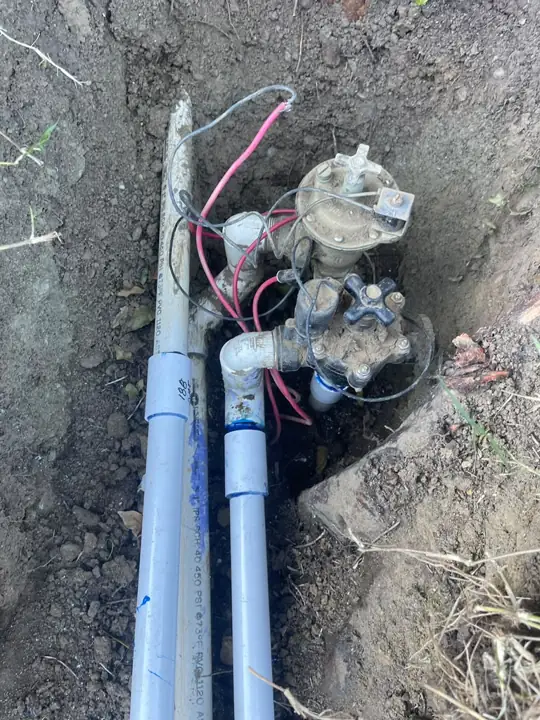 Sprinkler valve manifold with two irrigation valves and new PVC pipe during a commercial sprinkler repair in Mountain View